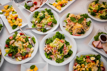 Buffet table of reception with cold snacks, meat and salads