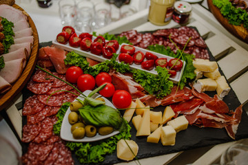 Delicious snacks with bacon, tomatoes, cucumbers and bread