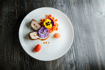 top view two pieces of baked meat with pepper salad decorated with flowers