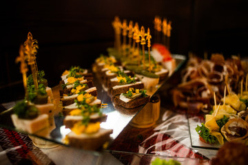 Buffet table of reception with cold snacks, meat and salads