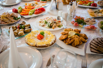Buffet table of reception with cold snacks, meat and salads