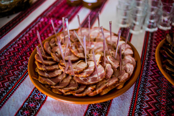 Delicious appetizers with bacon on a banquet table