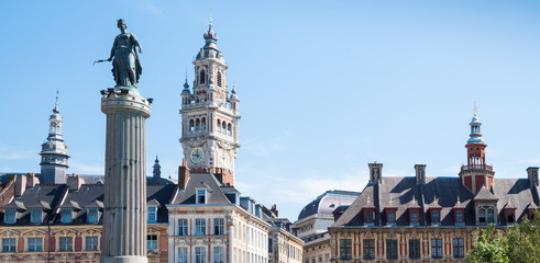 banner. tower of Chamber of commerce, buildings at central town square in Lille, France. white sculpture,  against blue sky. space for text