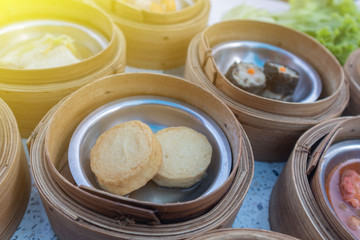 close up of variety dim sum in bamboo basket