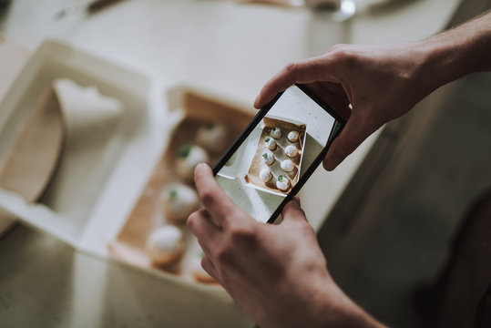 Person taking photos of the pastry with smartphone
