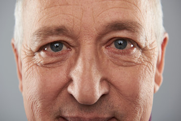 Grey eyes of adult man looking wise and calm
