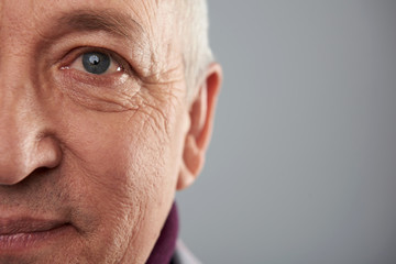 Close up of smiling adult with wrinkles on his face