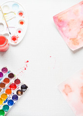 Palette with paintbrush and watercolors, top view, vertical