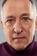 Portrait of mature man with wrinkles on his facial skin