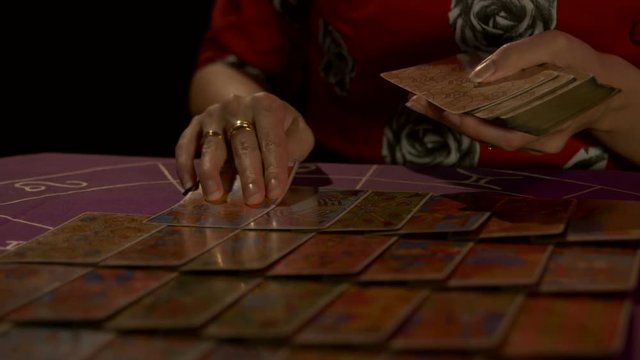 Tarot reader dealing cards & reading future and fortune. 4k