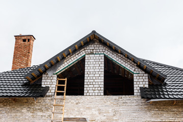 Construction of a pitched roof. Sheathing of metal roof. Roof slope.