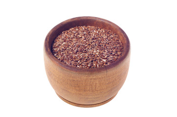 Brown flax seeds in wooden bowl isolated on white background