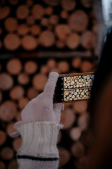Photo of a smartphone taking a photo of a stack of wood