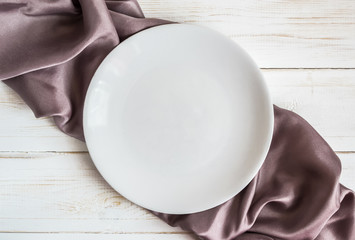 White plate on checkered lilac satin napkin