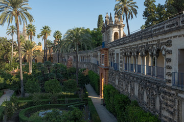 Fototapeta na wymiar Looking alongside the ornate internal wall of the gardens inside the Royal Alcazar Complex Seville, Spain