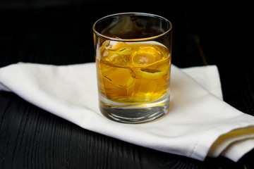 whiskey with ice on a wooden table