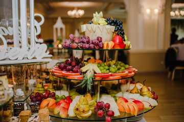 Beautiful fruity bright assorted sliced fruit on a rich festive table