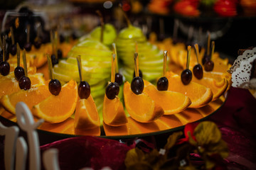 Beautiful fruity bright assorted sliced fruit on a rich festive table