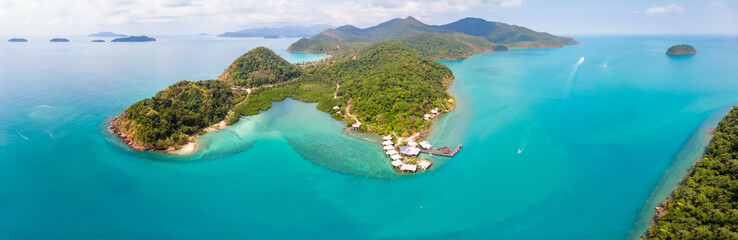 Tropical landscape aerial panorama with island coastline and beaches surrounded by transparent blue sea water, green rainforest, panoramic view from drone, summer vacation holidays destination