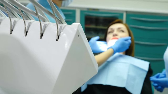 At Dental Clinic.Dentist examining a patient. Portrait of female patient in dental clinic being check up. Visit to the dentist. Consultation with the orthodontist, the installation of braces and the