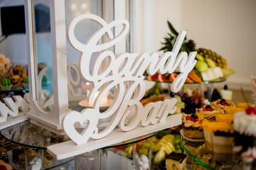 Exotic, organic fruits, light snacks in a plate on a buffet table. Assorted mini delicacies and snacks. Decorated delicious table for a party goodies