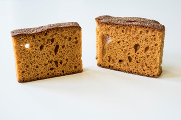 close up slices of typical Dutch spiced caked called ontbijtkoek or peperkoek. Against white background