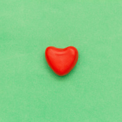 plasticine red heart on a green background