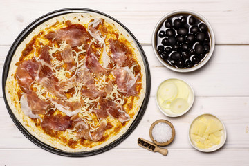Add olives, onion, salt, pepper, parmesan. recipe step by step pizza capricciosa flatlay on white wood