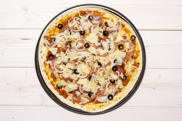 Ready to oven step. recipe step by step pizza capricciosa flatlay on white wood