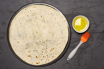 Grease pita with olive oil. recipe step by step pizza capricciosa flatlay on grey stone
