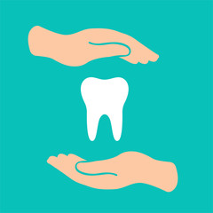 colored hands holding a tooth care symbol on a blue background