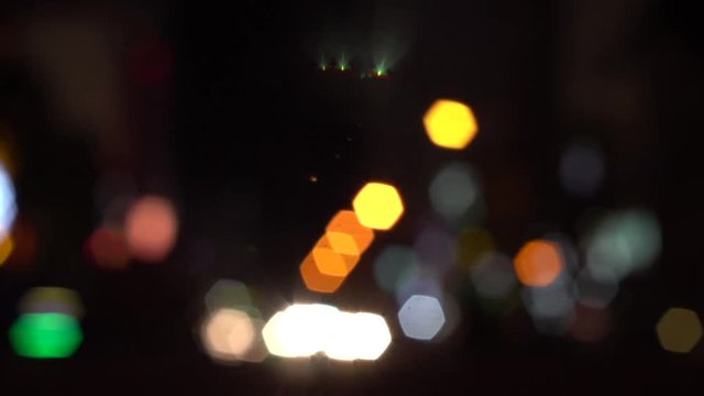 Background image of city traffic at night with bokeh car headlights.