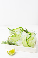 Fresh cucumber drink sprig of rosemary on a white background. Summer refreshing detox. Selective focus.