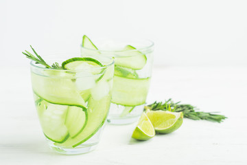 Fresh cucumber drink sprig of rosemary on a white background. Summer refreshing detox. Selective focus.