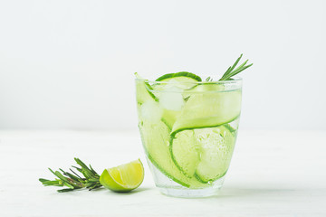 Fresh cucumber drink sprig of rosemary on a white background. Summer refreshing detox. Selective focus.