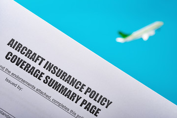 aircraft insurance policy coverage summary with a flying aircraft model on background