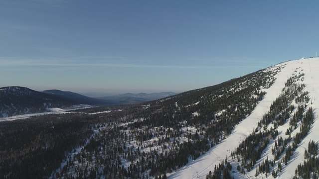 Winter mountain landscape with mountains and blue sky