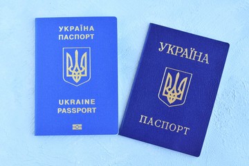 Internal passport of Ukraine with a state emblem trident and biometric document for international travel with personal id data. Passport of a citizen of Ukraine and id passport on neutral backdrop 