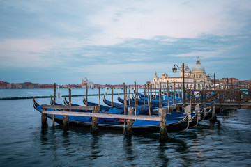 Fototapeta na wymiar Gondolas and Santa Maria della Salute in the background in Venice, Italy