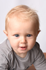 blond baby with gray clothing