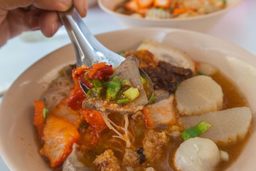 spicy tom yum noodle with pork and meat ball at thailand