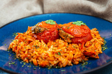 stuffed tomatoes with rice on a white plate