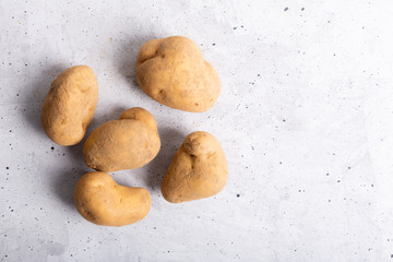 Trendy ugly organic potatoes on the table