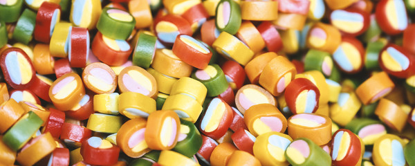 Colorful lollipops and different colored round candy. Top view.