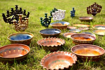 Products from ceramics close up. Folk craft Latvia. Traditionally, the products are painted with restrained, earthy shades. Best pottery for home.