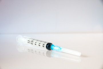 Syringe on grey background