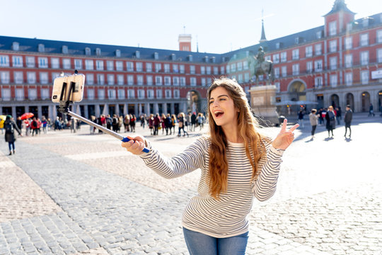 Attractive happy young woman taking a self picture. In tourism leisure outdoors concept