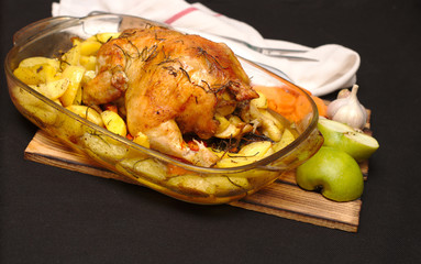 oven-baked crispy crust stuffed chicken on a plate with potatoes and apples