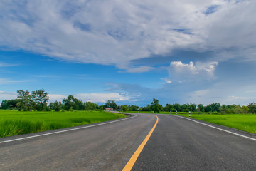 Fototapeta premium Yellow line on the asphalt road with blue sky. 