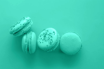 Macaroons of rich blue with turquoise hues on a blue background. Dessert.